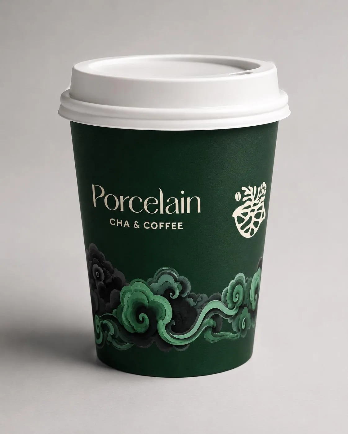 A Porcelain cup in dark green glaze with cloud-work